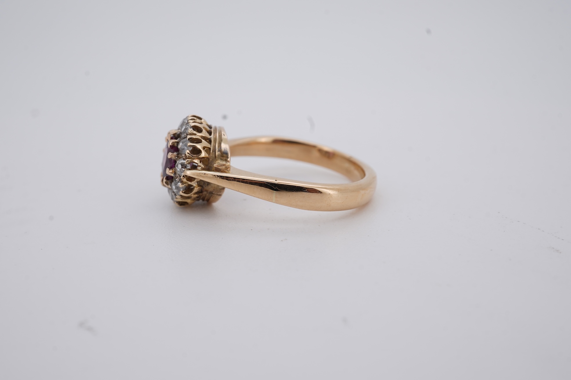 A George V 18ct gold, ruby and diamond set circular cluster ring, size M, gross weight 5 grams.